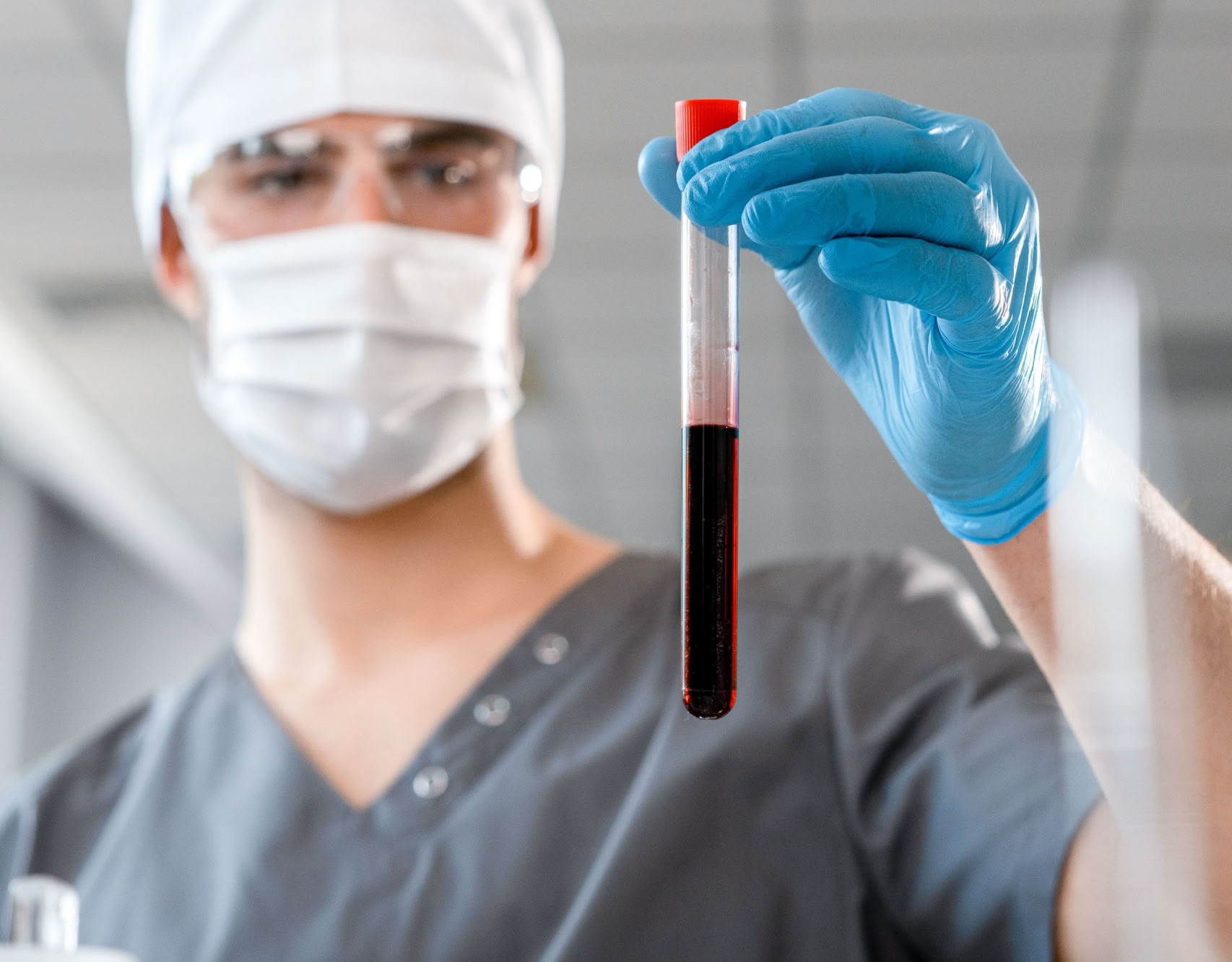 Doctor examining a blood sample in a laboratory setting, showcasing medical research.